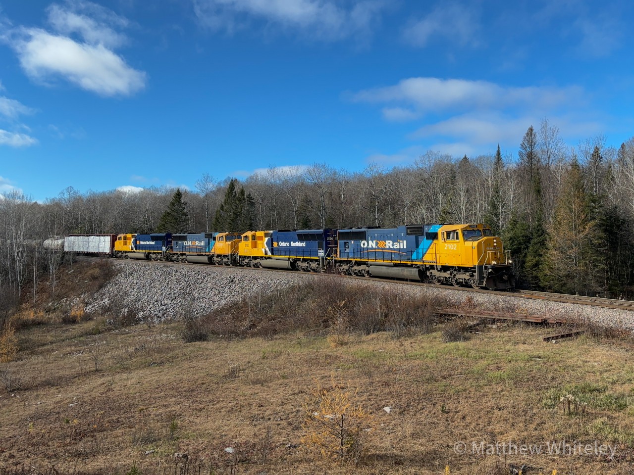 ONR Englehart-North Bay train 214 is captured traversing the rugged Northern Ontario landscape with SD75i 2102 in the lead. Trailing units were 2120 (SD70M), 2104 (SD75i), and 2121 (SD70M).

At North Bay, the crew would switch consists and lift SD75i 2105 from the shop before heading north to Englehart as train 113.