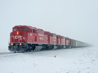 Despite the thick ice-fog, a four-pack of SD40-2s leading a loaded grain train on the mainline is worth going out for.  CP 9021, 9022, 9023, and 5875 do the honours of leading train E08 into Regina from the Last Mountain Elevator.  