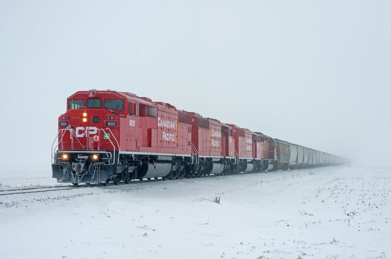 Despite the thick ice-fog, a four-pack of SD40-2s leading a loaded grain train on the mainline is worth going out for.  CP 9021, 9022, 9023, and 5875 do the honours of leading train E08 into Regina from the Last Mountain Elevator.