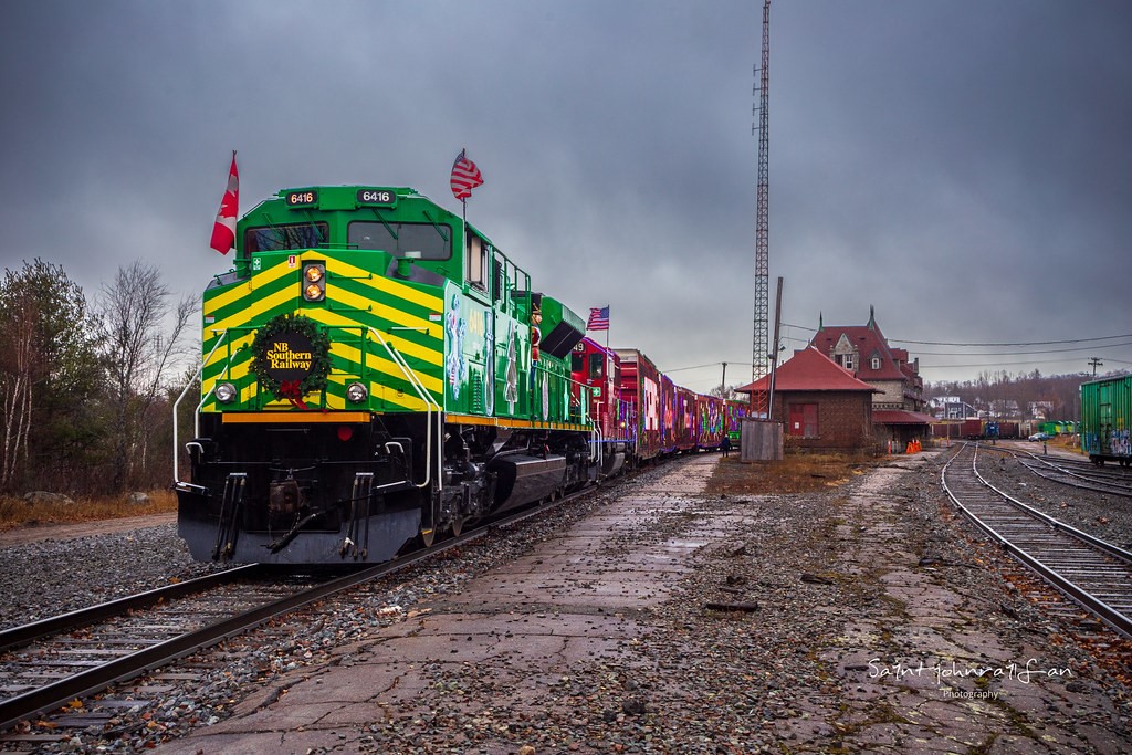 For the first time in it's history, the CPKC holiday train has made it's way onto New Brunswick soil. After performing in Saint John the night before, the holiday train is seen here parked at the station in McAdam, New Brunswick for a small performance before continuing west into Maine. CPKC and NBSR did a great job at teaming up for this train, with NBSR decorating two engines in Christmas livery. The red and green go great together.