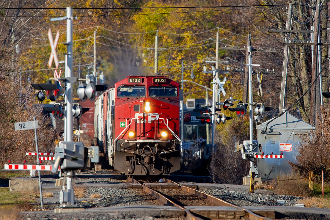 Most of the leaves have fallen except for a small patch of trees which are still hanging on as CP 8102 leads an eastbound through downtown Belleville.