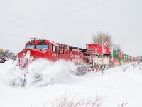 CP 113 makes its way west to Toronto through one of the last snowfalls of 2023.  The CP red sure adds some colour to an otherwise dull day.