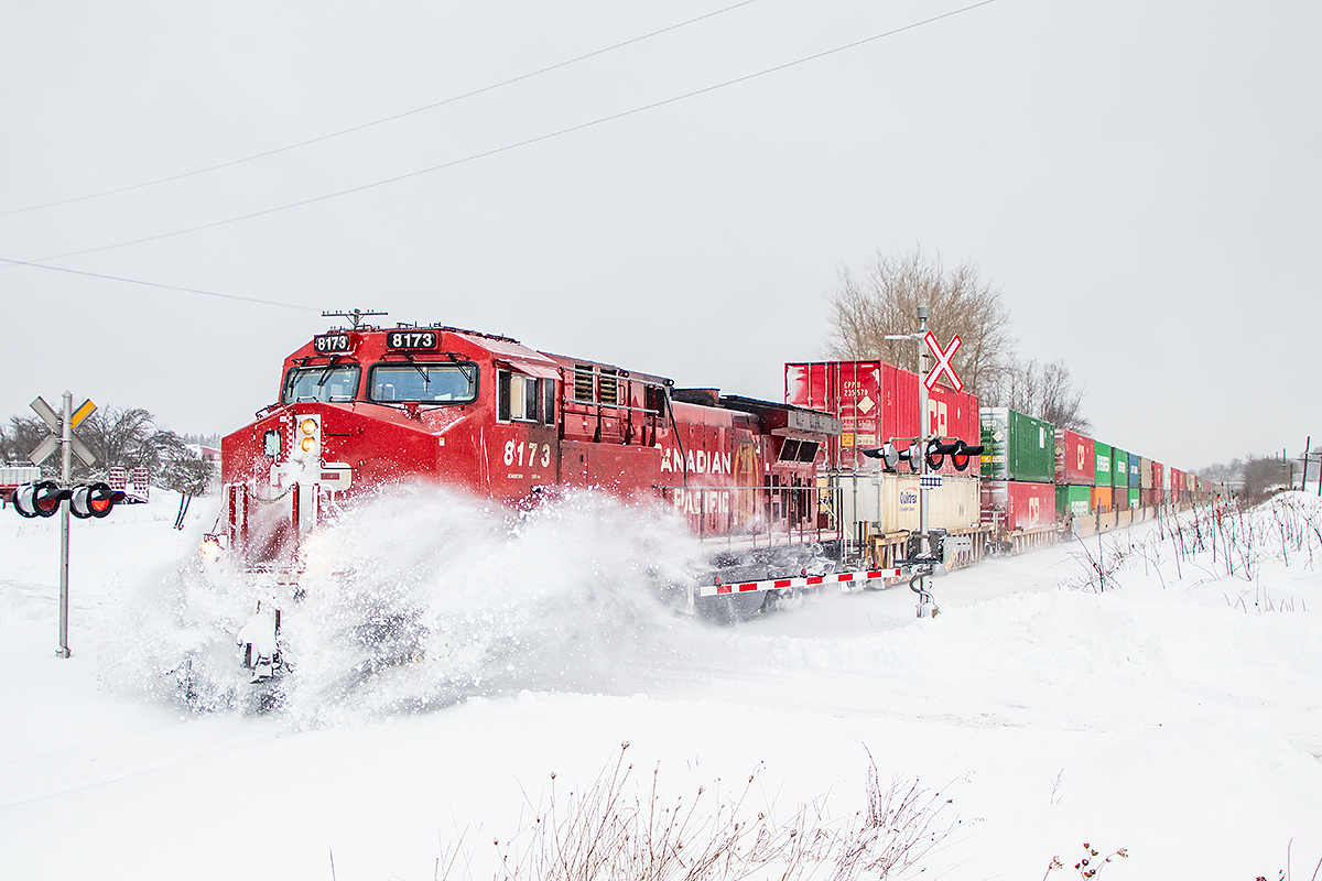 CP 113 makes its way west to Toronto through one of the last snowfalls of 2023.  The CP red sure adds some colour to an otherwise dull day.