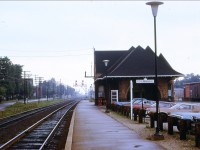 On a rainy day the CNR Brampton station sits rather lonely with a lone CNR box car at the OCS unloading dock. It won't be long that those absolute signals might get up-graded now that the old Credit Valley RR (CPR Orangeville Sub.) diamond is no longer... Taken from my fathers collection.