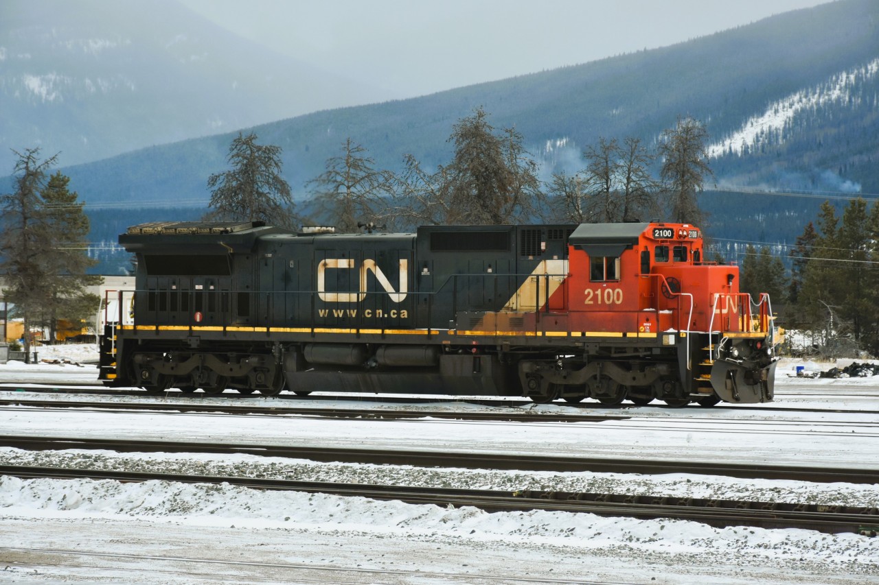 Training Mode  
CN 2100 sits in the yard at Jasper, AB on this cold and hazy afternoon waiting the next tour of duty with new conductor trainees.