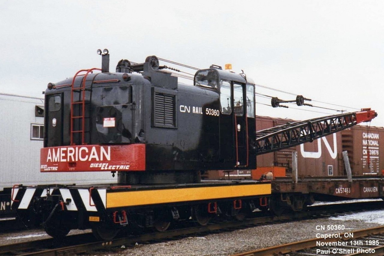 Old Dog  
CN 50360 (1st) is an American model 830 DE locomotive crane, serial number J-3478 built in 1958. 
After serving for several decades as a workhorse on the mainlines of northern Ontario, it has received an overhaul and fresh paint before being relegated to yard duty at the Capreol Work Equipment Repair Facility. br>
Hard to believe is has been 39 years to the day since I snapped this pic. 
CN 50360 was involved in a derailment and wrecked on February 16, 1999 at Mac Yard Concord, ON. It was scrapped on site.