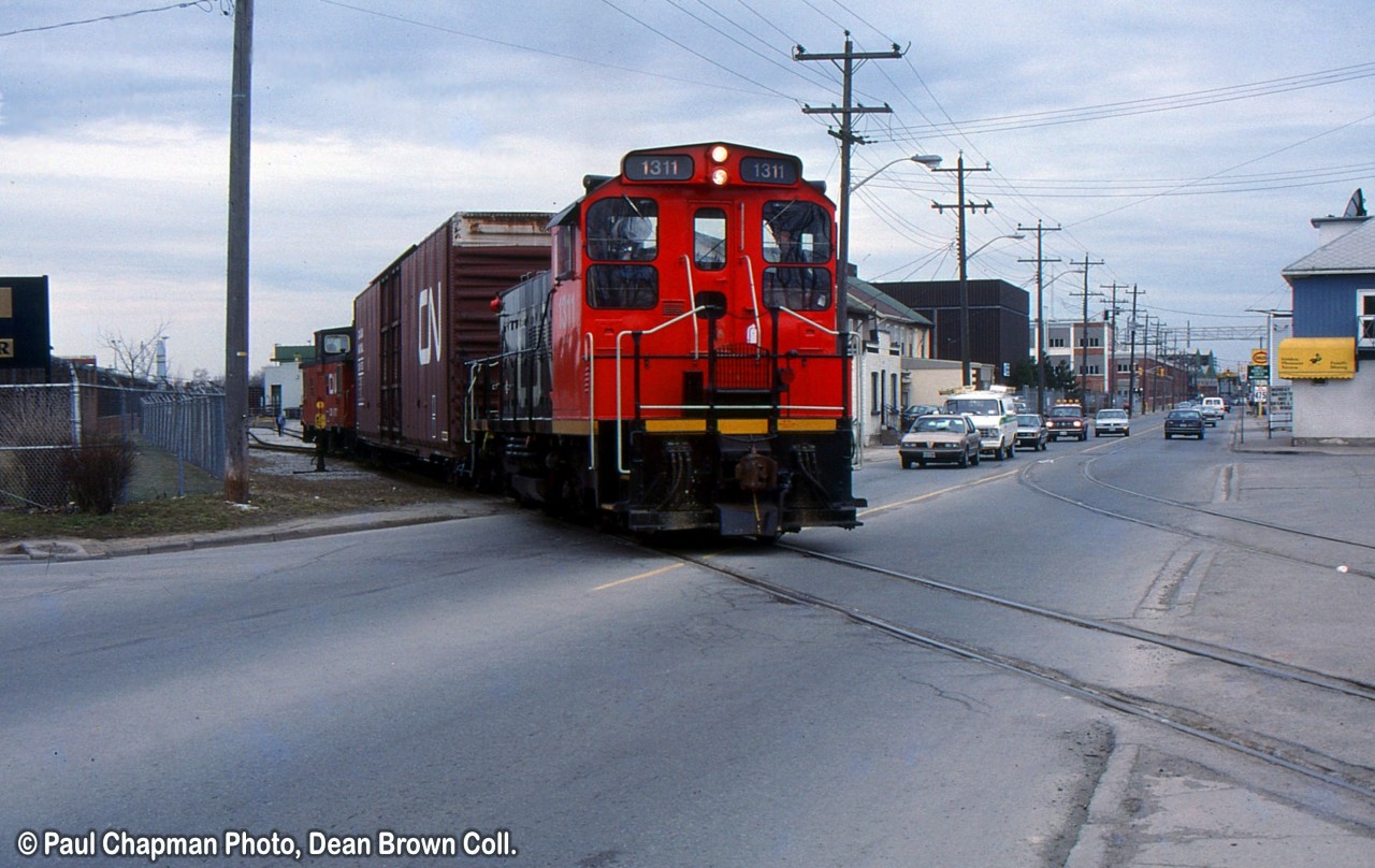 CN 549 with CN SW1200RS 1311 heads southbound leaving GM Ontario St. plant.