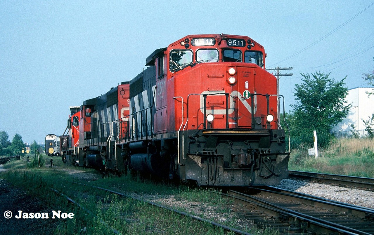 During a summer evening, CN train 421 is seen performing it’s work at the Kitchener yard with GP40-2L(W) 9511, another GP40-2L(W) and a GP9RM. The GP9RM was either set-off in the yard or continued to Stratford or London.  Also, there appears to be a dimensional load behind the power that possibly originated from Babcock & Wilcox on the CN Fergus Spur.