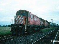 A short CP eastbound with C-424 4223 and SD40-2 5718 are pictured waiting at the east siding switch Wolverton for a meet with a westbound on the Galt Subdivision. The siding is situated just west of the town of Ayr, Ontario and is now home to a large CPKC yard and auto compound. 