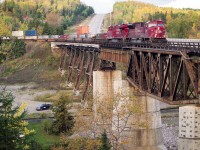 Eastbound CP train #116 with SD90MAC 9111 on the lead is seen crossing the Nipigon River bridge on a late September afternoon in 2007.
Whenever I am around Nipigon I hang around a bit in hopes of catching a train here on account I love the rugged scenery in the area.
I kinda miss the MACs as well, with this one now rebuilt as SD70ACU #7031; I am thinking these rebuilds are just as much of annoyance to the Maintenance Shop as the MACs were.
Second unit is CP 8778. Track down below has now been lifted; it was the old CN Kinghorn Sub.