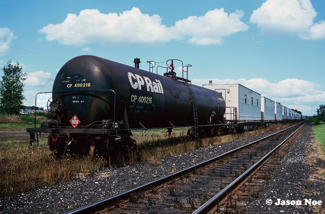 A CP work train is viewed sitting in the village of Ayr, Ontario on the Galt Subdivision. I don’t have any information on why the train was set-off here, as it caught us by surprise at the time. Also, I believe this was the first and only time I ever photographed a CP Rail tank car.