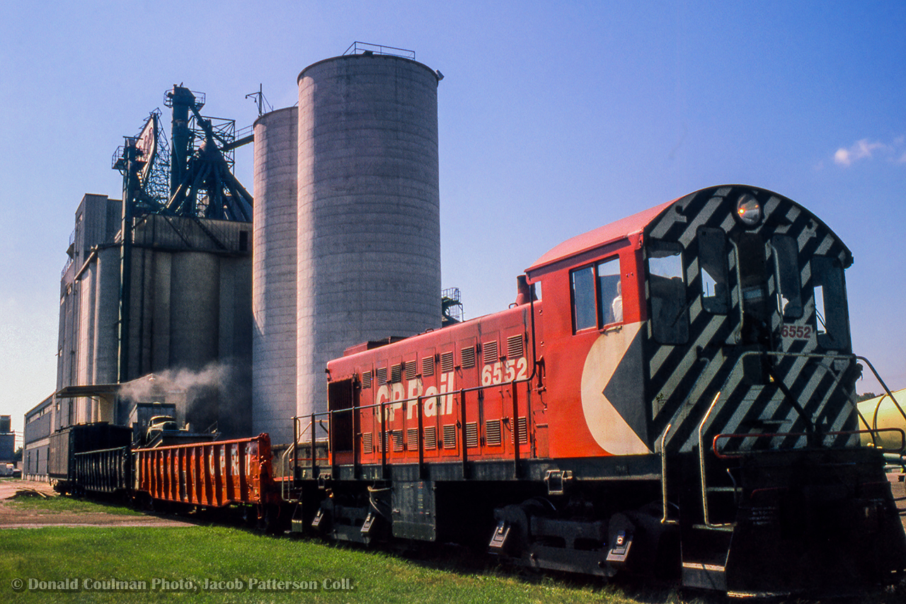 CPR MLW S3 6552 is seen spotting a car at the Guelph United Dairy Producer's Co-operative (officially Gay Lea by this time) just off the CPR Goderich Sub at mile 33.  Originally constructed in 1949 (silos circa 1960), the Co-op was built on farmland owned by Guelph-born Operatic tenor, and later manager of the Metropolitan Opera of New York City, Edward Johnson (1878 - 1959), with the land having been sold in 1947 to the United Co-operative of Ontario. The Co-op would be renamed United Dairy and Poultry Co-operative in 1958, and later the United Dairy Producer's Co-operative in 1967. In 1972, the organization was renamed Gay Lea Foods, which still operates the site today. The towering feed mill silos would be demolished in the 1990s and a processing plant built in it's place.

Donald Coulman Photo, Jacob Patterson Collection Slide.