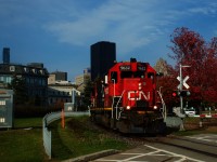 A crewmember waves as CN 500 leaves the Port of Montreal.