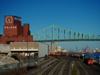 CN 500 is leaving the Port of Montreal with tanks and hoppers. At left, buildings that I believe were transport docks for Molson are being demolished. They are no longer needed, with Molson moving its centuries-old plant to the South Shore a couple of years back.