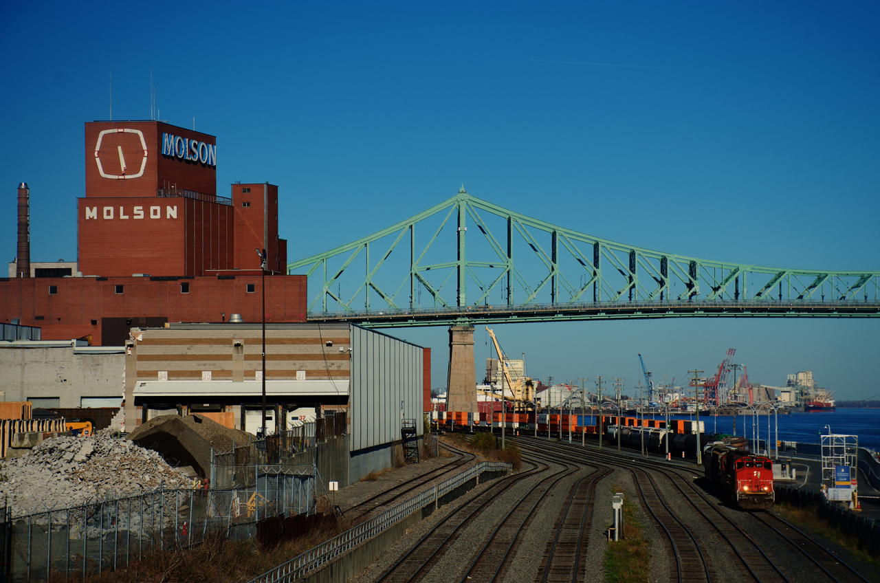 CN 500 is leaving the Port of Montreal with tanks and hoppers. At left, buildings that I believe were transport docks for Molson are being demolished. They are no longer needed, with Molson moving its centuries-old plant to the South Shore a couple of years back.