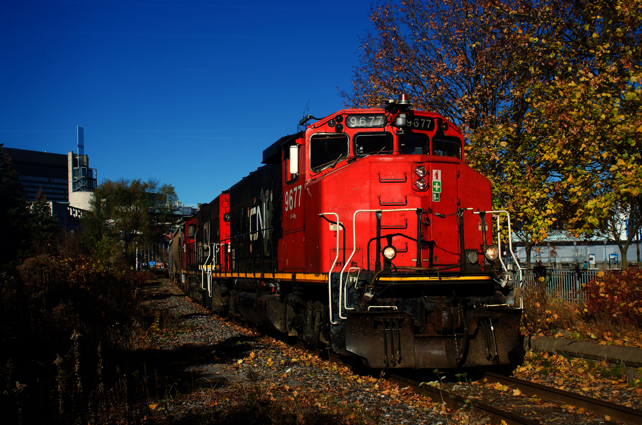 CN 9677 leads CN 500 past some fall colours in the Port of Montreal.