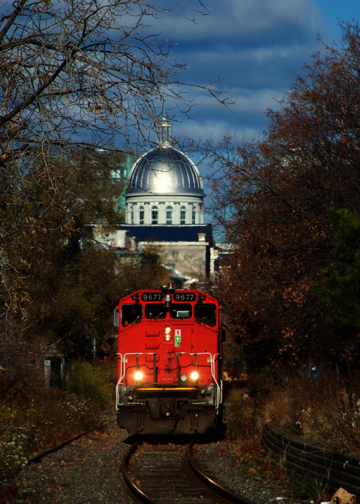 The dome of Bonsecours Market looms above as CN 9677 leads CN 500 out of the port.