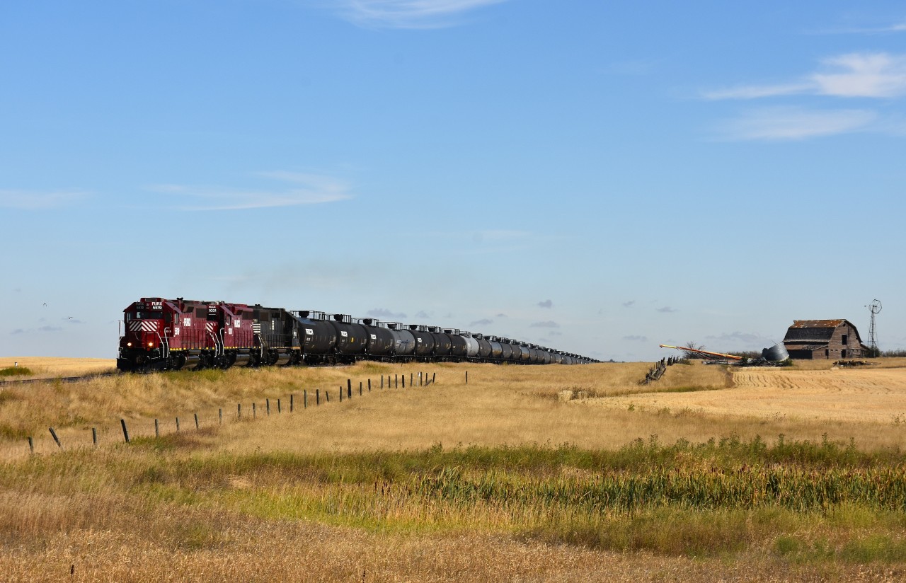 A gas train had just departed Leader, SK and is about half way to the hamlet of Mendham when we caught up with it. The train is on the way to Burstall, another 23 miles down the line where it will work an energy facility there.  Track speed is 10 MPH. Power consists of FURX 5519 (with Great Sandhills decal on side) HLCX 1031 and a former NS 5543; a unit which I saw on Wheatland Rwy a couple of years previous.
The location I shot this at I believe is Township Rd 220, and we are about 2 miles out of Leader, the hub for the GSR.
I was under the impression short lines did not work weekends, yet here it is a Sunday and there were trains operating on both ends of the roughly 130 mile line.  Busy times !!