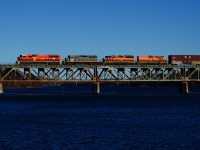 SLR 520 is crossing the Richelieu River in Otterburn Park with SLR 4023, QGRY 6904, SLR 3805, SLR 805 & 74 cars, on its way to CN's Southwark Yard. SLR 4023 is a recently repainted ex-BNSF SD70MAC.