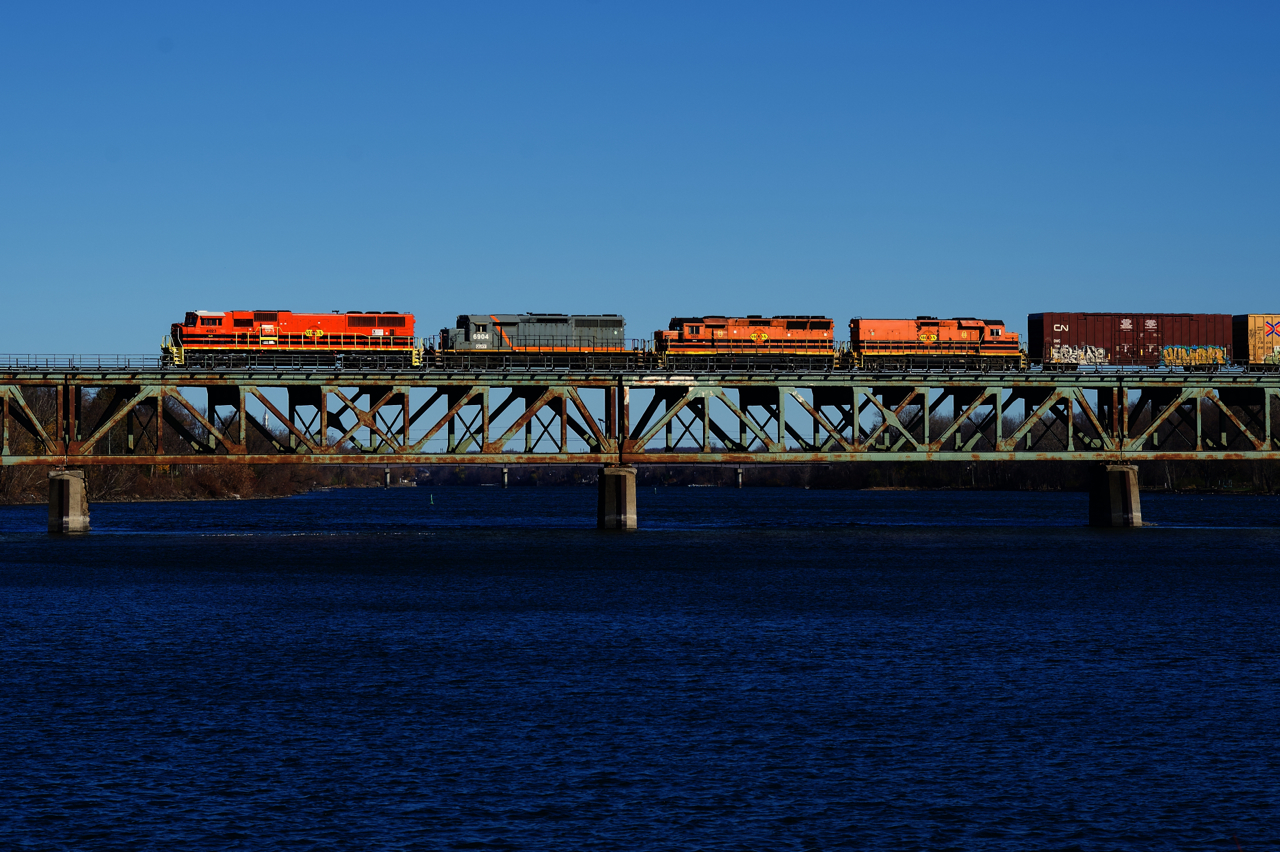 SLR 520 is crossing the Richelieu River in Otterburn Park with SLR 4023, QGRY 6904, SLR 3805, SLR 805 & 74 cars, on its way to CN's Southwark Yard. SLR 4023 is a recently repainted ex-BNSF SD70MAC.