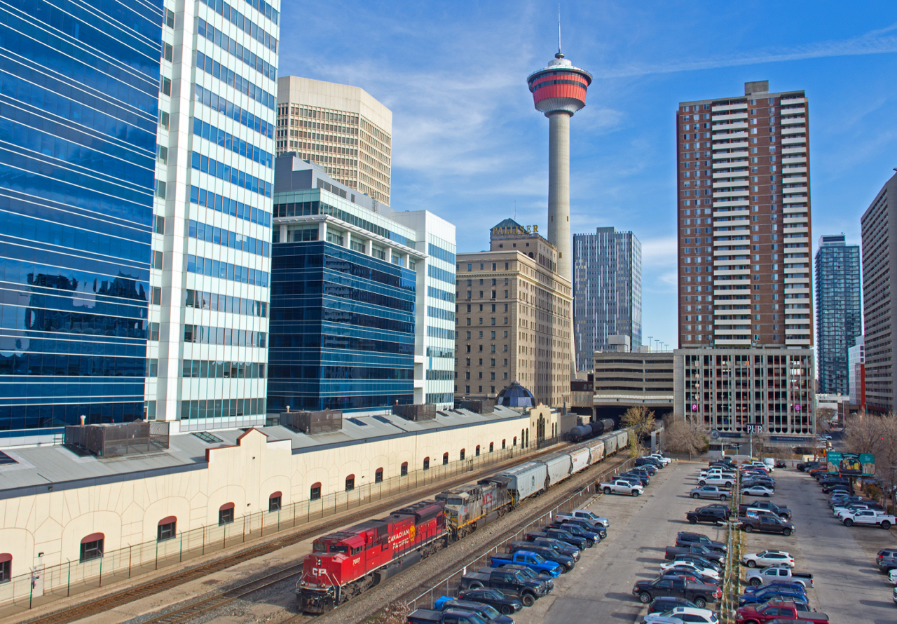 A westbound CPKC grain train is seen stretching out into downtown Calgary as it makes a large double over.