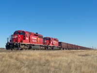 A sharp looking set of recently rebuilt SD40-2s lead a GPS ballast train west along the Swift Current Sub at Rush Lake.  