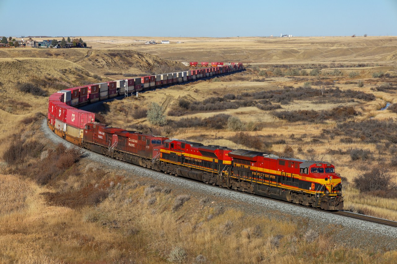 CPKC 118-31 grinds upgrade out of Medicine Hat with a colourful lashup. KCS 5003, KCS 4001, CP 8773 and CP 8752.  The two CP units will come off at Swift Current to power up a grain train.