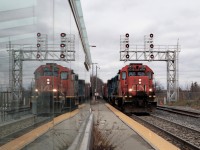 This shot took weeks in the making and many attempts to get it right. It has to be cloudy, (wrong side of tracks), it has to be a westbound, it has to have an engine, (not a GO cab car), and before my pick up time for the grandkids. The only real shot at this is CN 540 or a Via in daylight hours. On this day, I finally, after just over an hour of waiting and freezing, saw the headlight around the bend. CN 4725 with CN 4906 head through Guelph Station on their way back to Kitchener with a nice reflection off the glass shelter. 