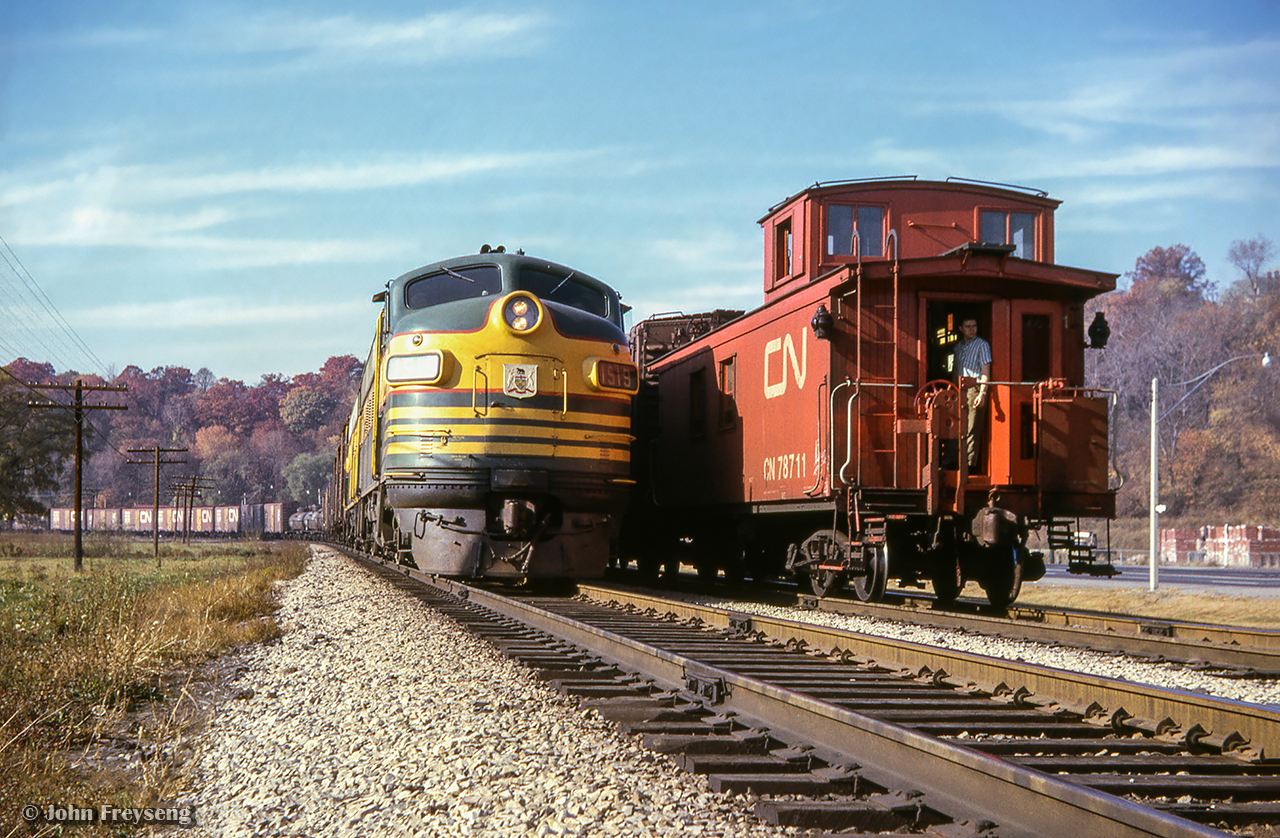 Toronto - North Bay train 459, led by F7s 1519, 1521, hold the main at the north end of Rosedale in the Don Valley while North Bay - Toronto train 452 behind RS3s 1300, 1311 takes the siding.

Scan and editing by Jacob Patterson.