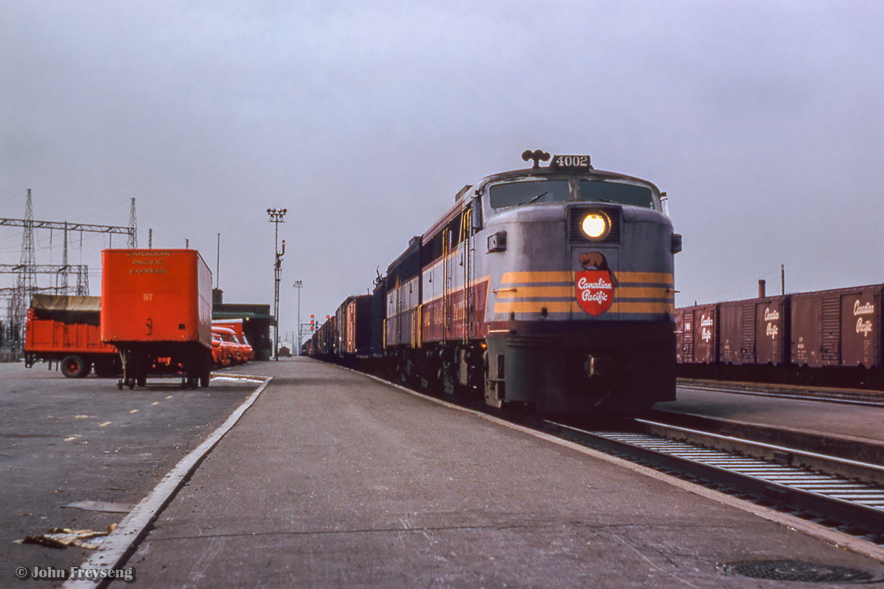 A pair of ALCO 244-powered units built by MLW lead an eastbound freight by Leaside, where a number of Canadian Pacific Express vehicles await their call.

John Freyseng Photo, Jacob Patterson Collection Slide.