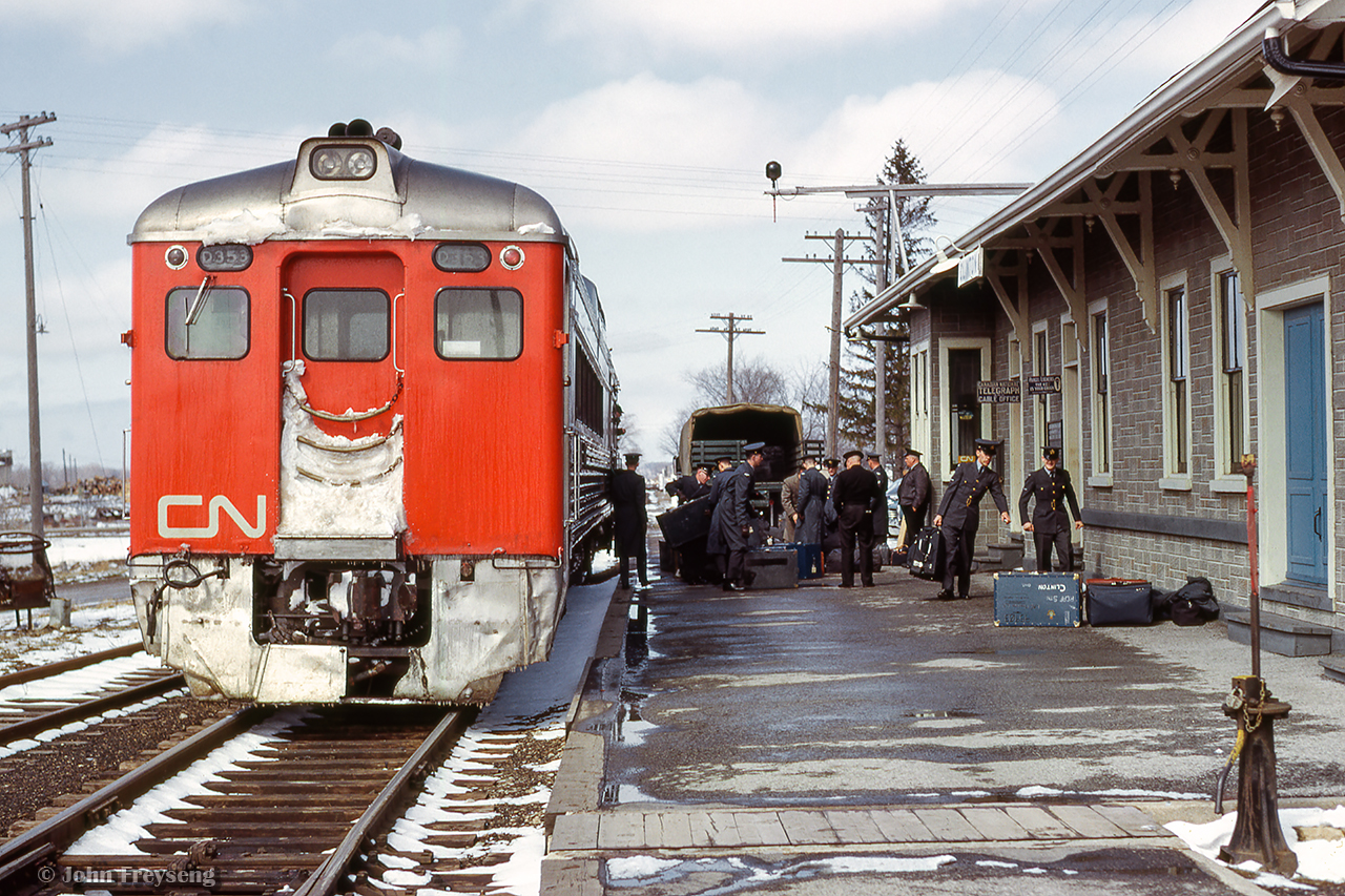 Westbound train 627 from Stratford to Goderich pauses at Clinton, where members of the Royal Canadian Air Force are disembarking for transport to the nearby base.

Scan and editing by Jacob Patterson.