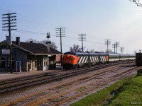 CN <i>Rapido</i> number 64 is about an hour into its 4 hour, 59 minute journey from Toronto Union Station to Gare Centrale Montreal as it blasts by Port Hope behind an A-B-A set of zebra-striped GMD FP9s.

<br><br><i>Scan and editing by Jacob Patterson.</i>