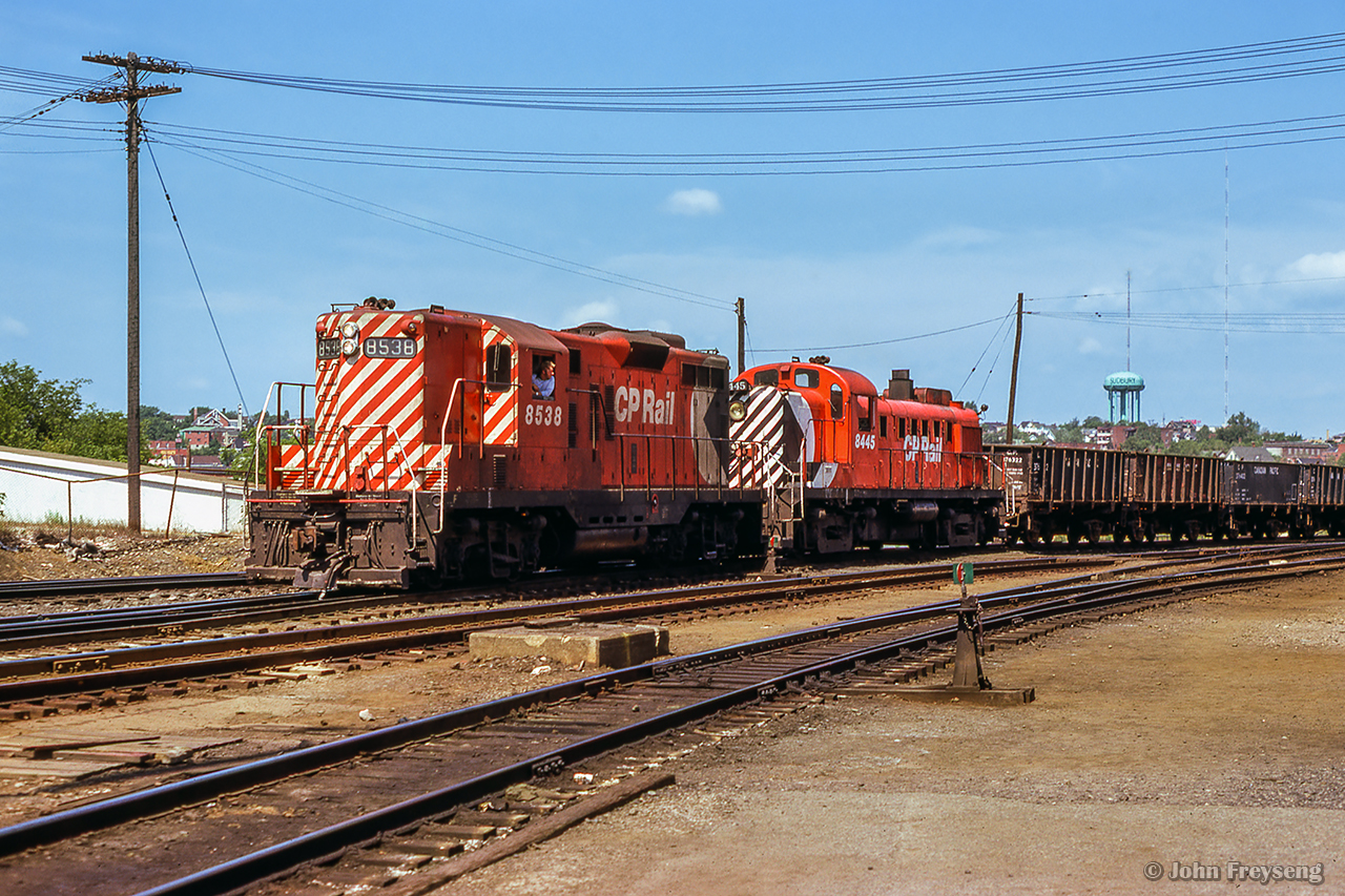 A pair of first generation diesels bring a cut of ore cars into Sudbury yard.Scan and editing by Jacob Patterson.