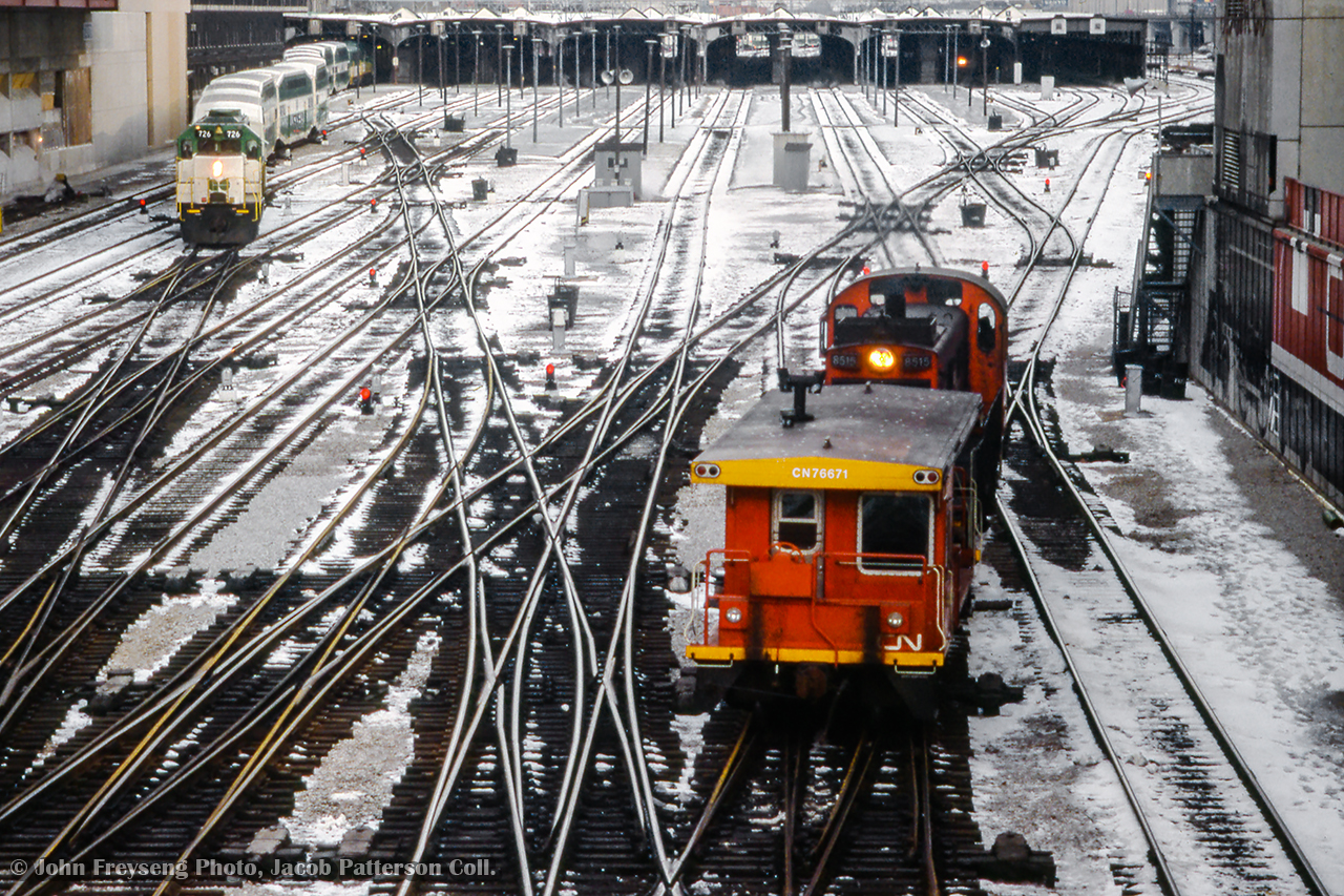 A snowy day around Toronto Union station finds MLW S13 8515 moving through the double slip switches with a transfer van while a GO train powered by GMD GP40TC 726 departs westbound.

John Freyseng Photo, Jacob Patterson Collection Slide.