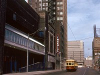 TTC Peter Witt streetcar 2766, operating on a fantrip during its early "Tour Tram" career, heads southbound on Victoria Street between Dundas and Shuter, passing the back of the old Imperial Six theatre (built as the Pantages Theatre in 1920, currently named the CAA Ed Mirvish Theatre) and the Imperial Optical building. In the background, Ryerson Polytechnical Institute's tan-coloured Podium (POD)/Library building is visible beyond Dundas at Gould.
<br><br>
<i>Tom Gascoigne photo, Dan Dell'Unto collection slide.</i>
<br><br>
On the same day at Parliament & Dundas: <a href=http://www.railpictures.ca/?attachment_id=53755><b>http://www.railpictures.ca/?attachment_id=53755</b></a>