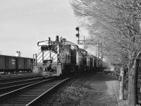 <br>
<br>
Extra 8141 West – with four pups, three with the CP Rail multimark on the cab - hits the Leaside diamond
<br>
<br>
Mile 206.0 Belleville Sub-Division
<br>
<br>
Mile 0.0 North Toronto Sub-Division
<br>
<br>
At Leaside, December 1978 Kodak Tri X negative by S.Danko
<br>
<br>

Likely The London Pickup ?
<br>
<br>
The first track – immediately to the left - is the Belleville Sub-Division  ' Don branch ' to Don station at mile 209.5 and onto the TTR trackage controlled by TTR Cherry Street Leverman.

