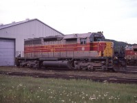 Algoma Central #180 sits outside the relatively new shop building in Hawk Junction. This unit would be around another 5 years or so before scrapping after being involved in a wreck.
I do miss the days of the AC. The area, now under CN is more like a desolate wasteland compared to back in the times I visited in the 70s & 80s.
An article I found on-line states that this unit was lost due to a derailment in 1980 caused a rail at mile 4  being removed by section men who had been fired by the company. This was how they showed their 'appreciation'.  Since I shot this image in 1985, I am thinking the date in the report was erroneous, instead of 1980 the incident probably occurred May 14, 1990.