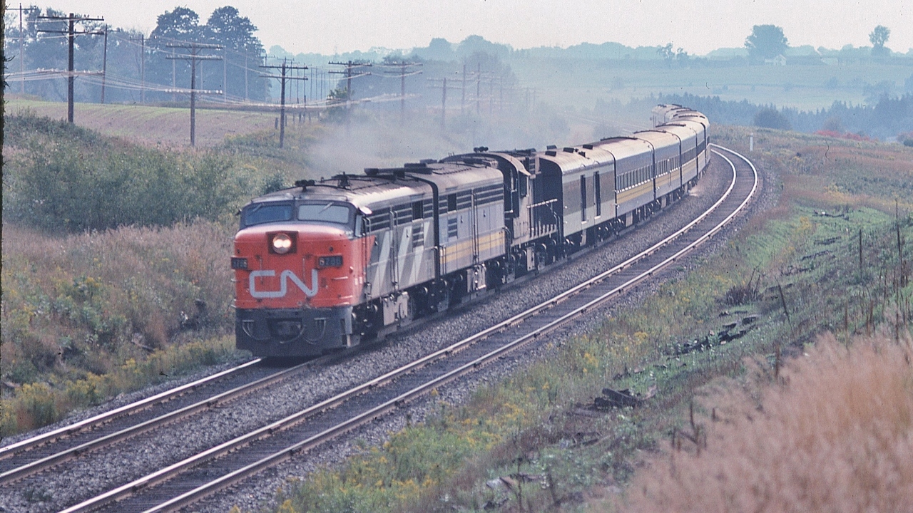 An all Canadian passenger train.


Designed in Canada. Engineered in Canada. Manufactured in Canada.


All weather, proven robust design. Operating on time. Reliable too.


MLW's at Speed on a steamy Labour Day weekend. 


At track speed, two baggage cars - head end and rear - the afternoon Bonaventure: Ottawa section removed at Brockville  


The view from the Bee Bridge, September 3, 1978 Kodachrome by S.Danko


also


Upper right: the Newtonville Rd bridge over the CP Rail Belleville Sub. 


Captured by a trustworthy Nikkor 135mm F1.8 lens with a sturdy Nikkormat EL.