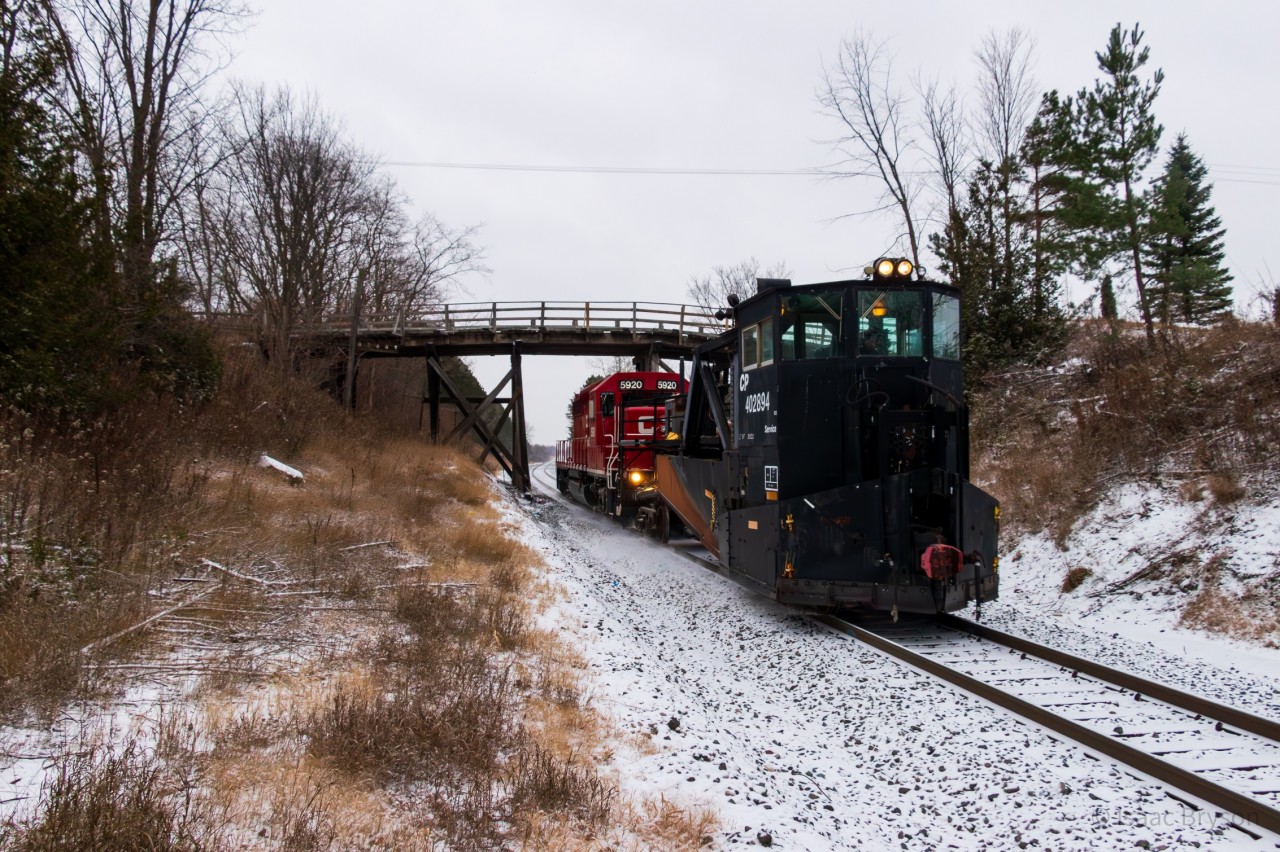 Me and a buddy made our way to Toronto yard on the morning of December 4th as we knew a work train was showing to dump CWR on the Mactier sub. Instead, we arrive to "the plow train" calling in the yard over the scanner. As they depart Toronto yard with Jordan Spreader CP 402894 and SD40-2 CP 5920, they tell RTC the plan: "up the Mactier sub, picking up a foreman in Midhurst, plowing maybe Medonte, definitely Buckskin & Bala; leave the plow in Bala and light power to Mactier. And the chase was on! Here they are ducking under the infamous 9th Line bridge near Beeton ON.