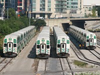 GO Transit cab cars 233, 202, 218 and 234 sit with their trainsets at GO's Bathurst North Yard in the late afternoon, as viewed from Bathurst Street bridge. They will soon be called to nearby Toronto Union Station for PM rush hour duties (the crew of 234 appears to be getting their set ready to depart soon).
<br><br>
At the time, the first group of cab cars (200-214) had already been rebuilt and equipped with a full-width cab (note the 2 front windows), and the second and third groups (215-223, 224-241) were undergoing rebuild, hence 233 freshly rebuilt, and 218 and 234 still waiting to lose their "ogre eye" single window look.