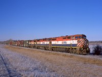 A trio of BCOL 4600s lead a short train of OSB boxcars from the LP mill in Fort St John toward Dawson Creek to be unloaded, then reloaded with the same material after a finishing process was applied.  This was during one of several slide-film-relapses I went through and was shot on a medium format camera (note the unusual aspect ratio), even in 2010 it cost close to $2 every time that shutter button was pressed. But a matching set of BC  Rails on a perfect November morning was worth it. 