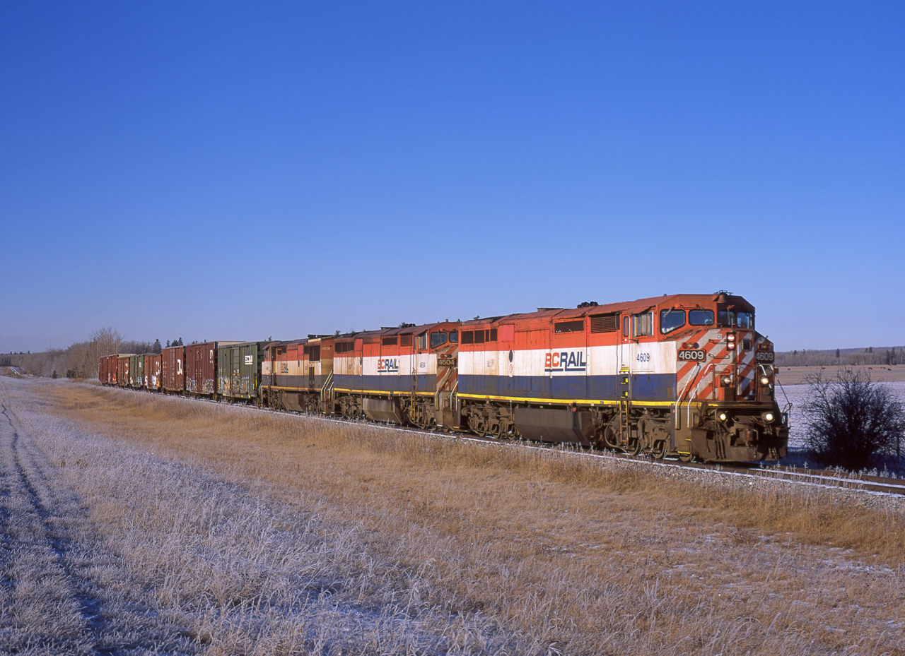 A trio of BCOL 4600s lead a short train of OSB boxcars from the LP mill in Fort St John toward Dawson Creek to be unloaded, then reloaded with the same material after a finishing process was applied.  This was during one of several slide-film-relapses I went through and was shot on a medium format camera (note the unusual aspect ratio), even in 2010 it cost close to $2 every time that shutter button was pressed. But a matching set of BC  Rails on a perfect November morning was worth it.