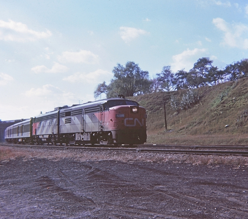 A sunny warm October afternoon, CN 6789 leading train #142 off the Dundas subdivision and eastward to Toronto. Nice sequential numbers on the loco 6-7-8-9. CN 6541 is the second unit. "Kodak Instamatic Memory" from long ago.