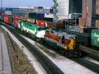 What might be the most unusual power set I have ever seen in Ontario.Power short CP had borrowed GO units and had leased Algoma Central #154 on a transfer from Lambton yard to Agincourt.Vantage point is the long gone Weston Road bridge over the diamonds