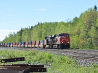 Another one of CN's many double-stack intermodal trains heads west through Milnet, Ontario on July 2, 2018 with a large cut of single stacks on the head end.  Power for the train is the 2959 and 2952.