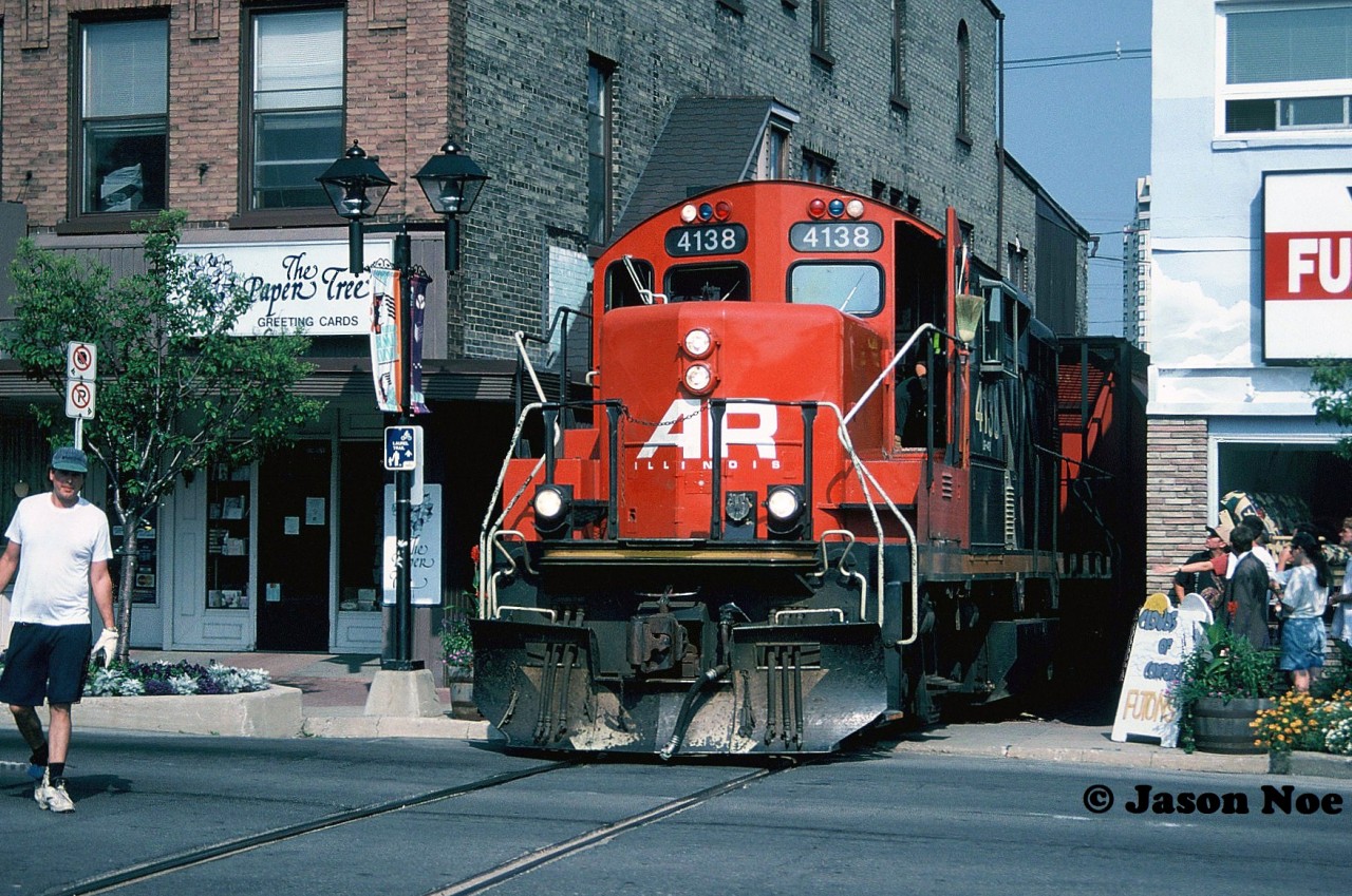 -rp.ca #1000 

A year after being applied, the AR Illinois graphic still looks fresh as 4138 leads the CN 15:30 Kitchener Job to Elmira on the Waterloo Spur, about to cross King Street in downtown Waterloo. This was the first time I had photographed 4138 on the line heading north since my cab ride three years prior. The mid-90’s was a simpler time in Uptown Waterloo, back during an era when CN trains to Elmira operated almost un-noticed in daylight. Except for those few devoted local fans that would regularly photograph them.