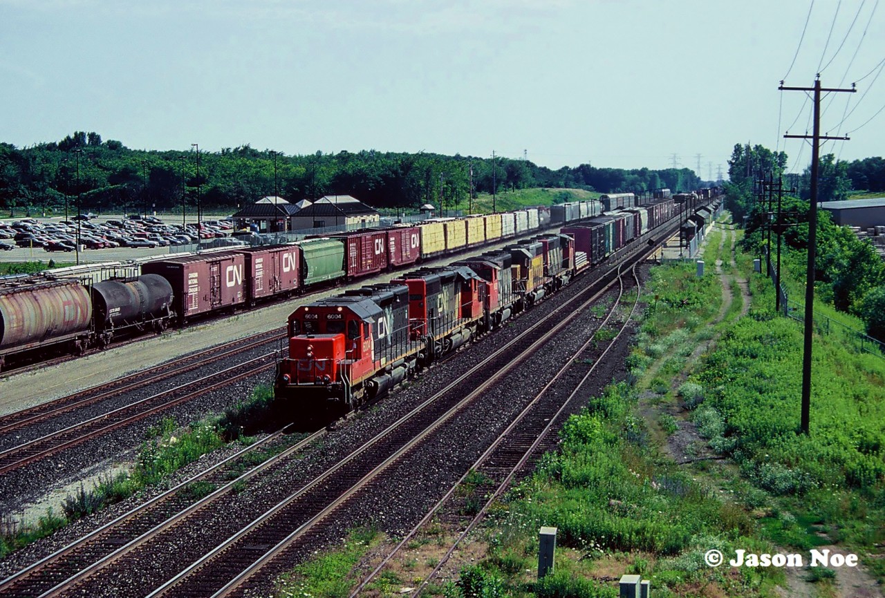 With its class lights on, CN SD40u 6004 heads west through the Aldershot, Ontario station on the Oakville Subdivision either destined for the Dundas or Grimsby Subdivisions. Behind the remanufactured SD is mix of units that includes another recently rebuilt SD40u and a newly acquired Union Pacific SD40-2 that would be later rebuilt into a CN 5300-series SD40-2 at AMF in Montreal, Quebec.