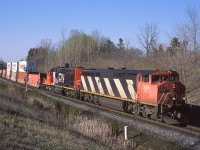 It's a perfect evening at mile 30 of Halton Sub as hotshot intermodal 143 drops downgrade with CN 2426 and IC 6111 up front. Both of these units are now off the roster. 