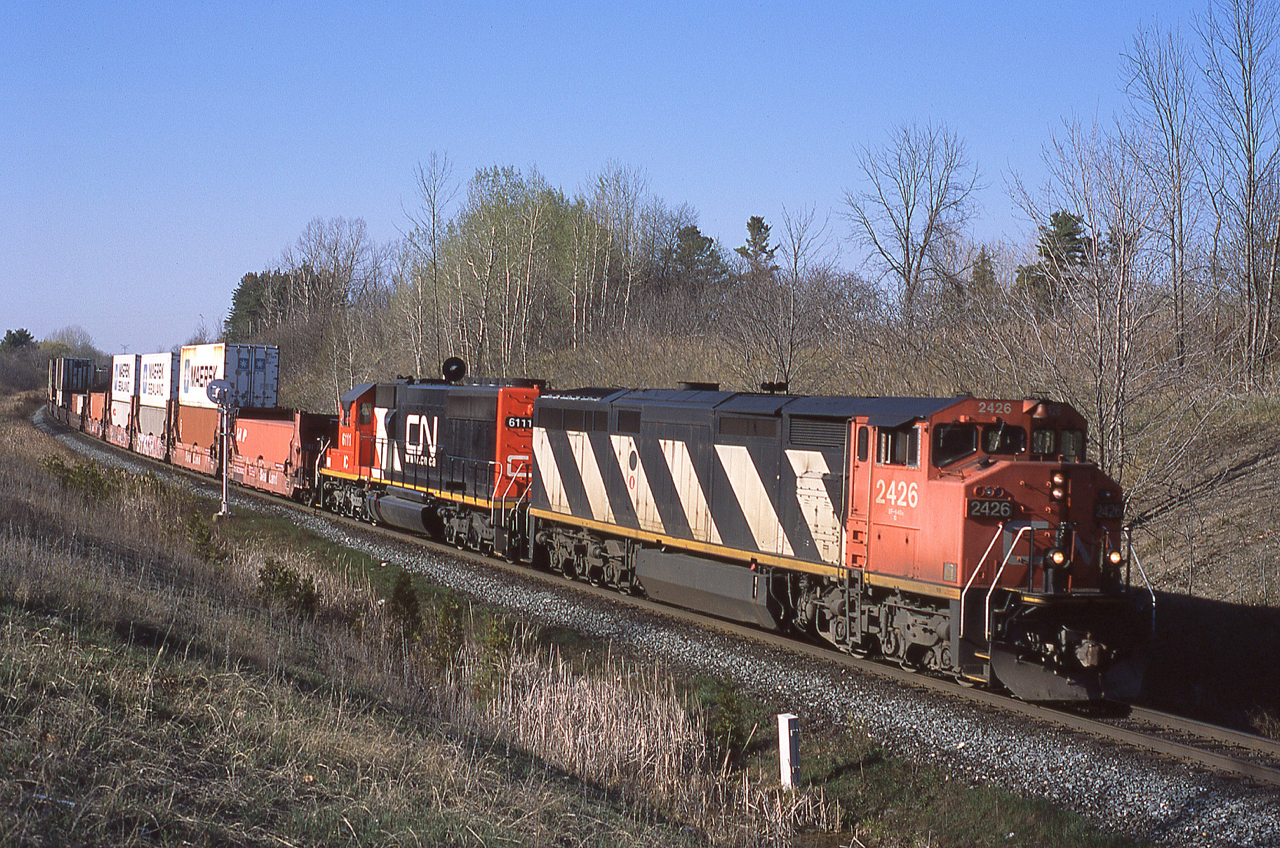 It's a perfect evening at mile 30 of Halton Sub as hotshot intermodal 143 drops downgrade with CN 2426 and IC 6111 up front. Both of these units are now off the roster.