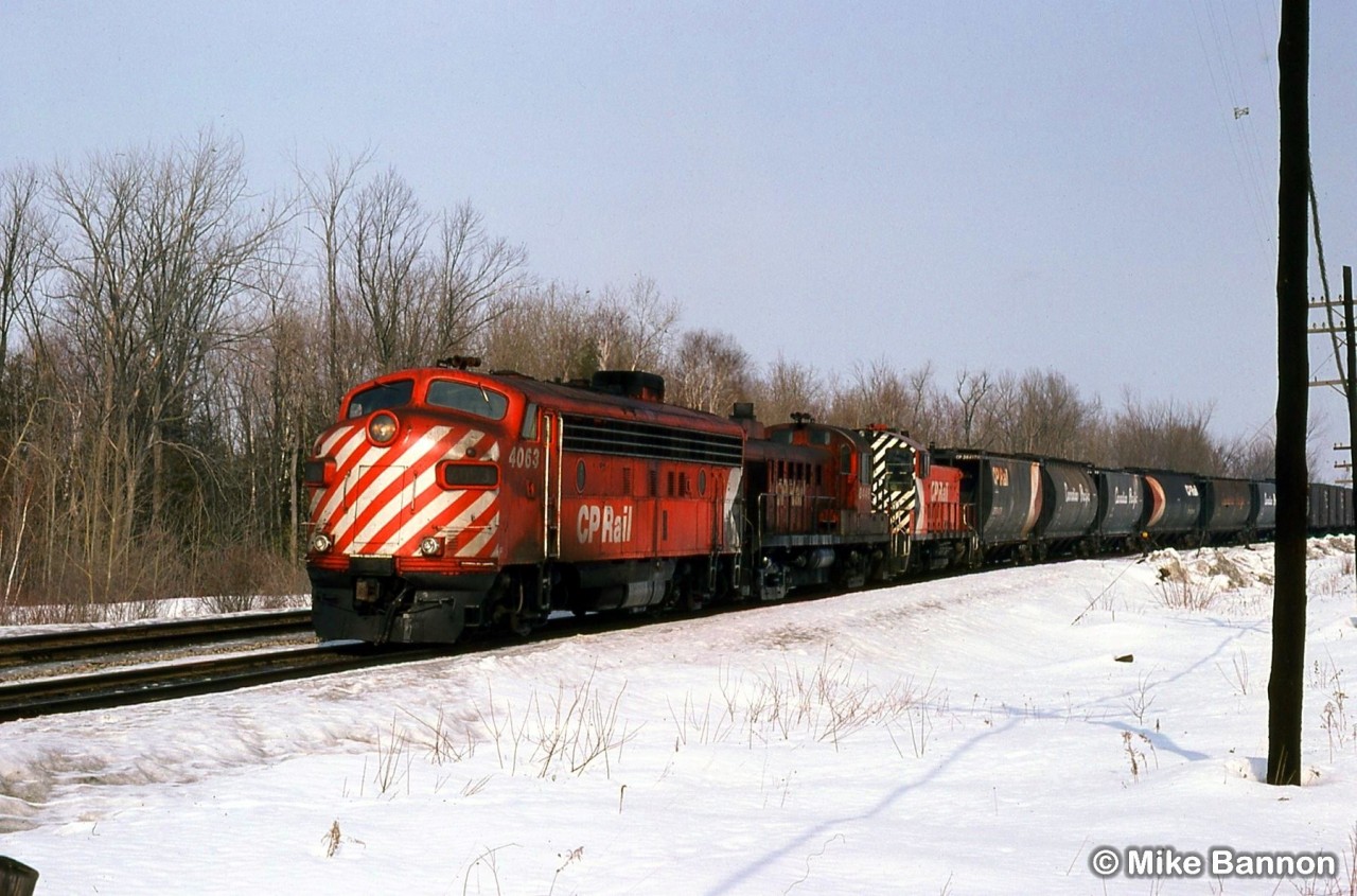 A southbound drag freight approaching the station with a mixed consist